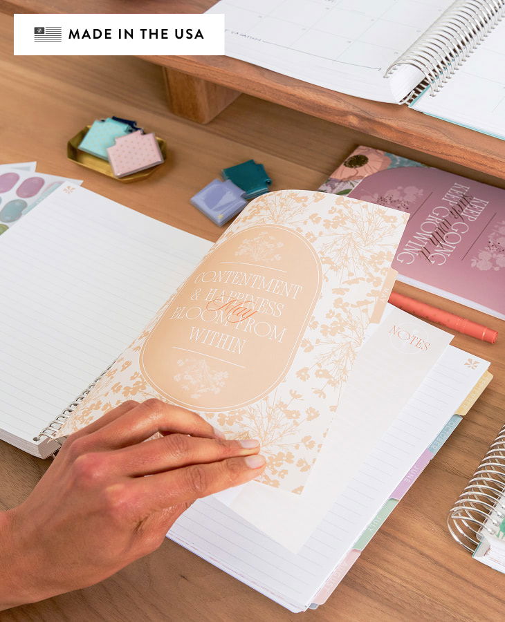 person flipping through coiled lifeplanner featuring Bouquet design.
