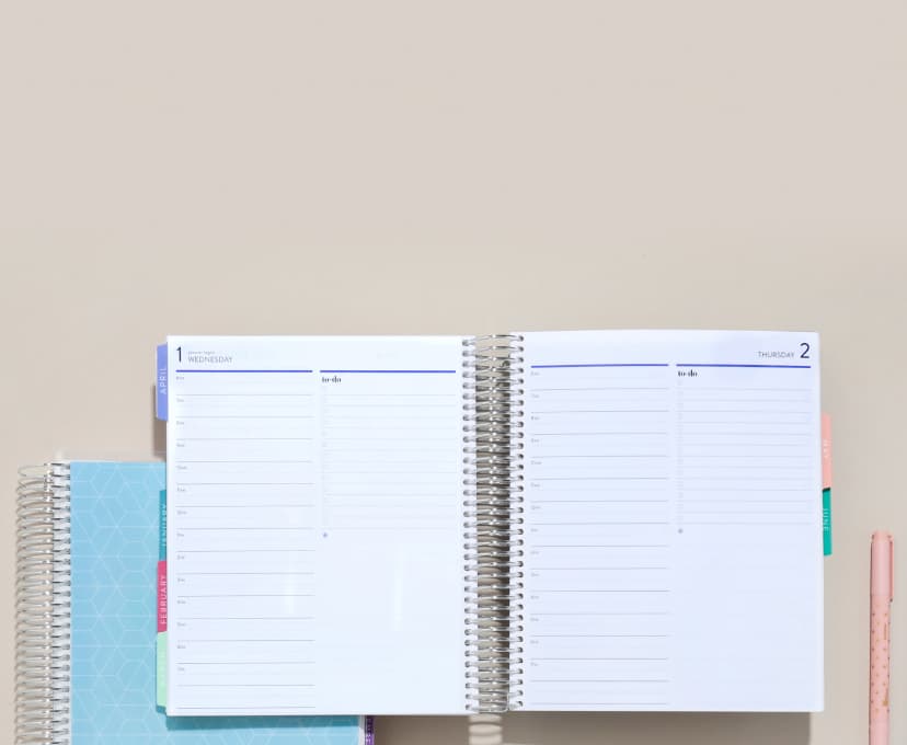 open coiled lifeplanner featuring daily layout with colorful accessories.